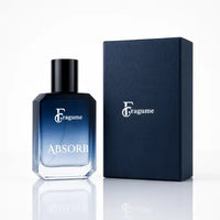 A bottle of Fragume Absorb fragrance with a blue gradient glass body and black cap, shown next to its dark navy textured box on a white reflective surface.