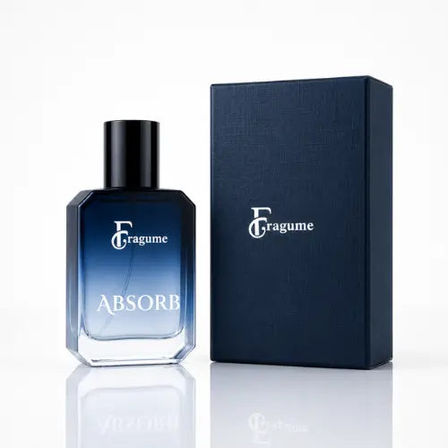 A bottle of Fragume Absorb fragrance with a blue gradient glass body and black cap, shown next to its dark navy textured box on a white reflective surface.