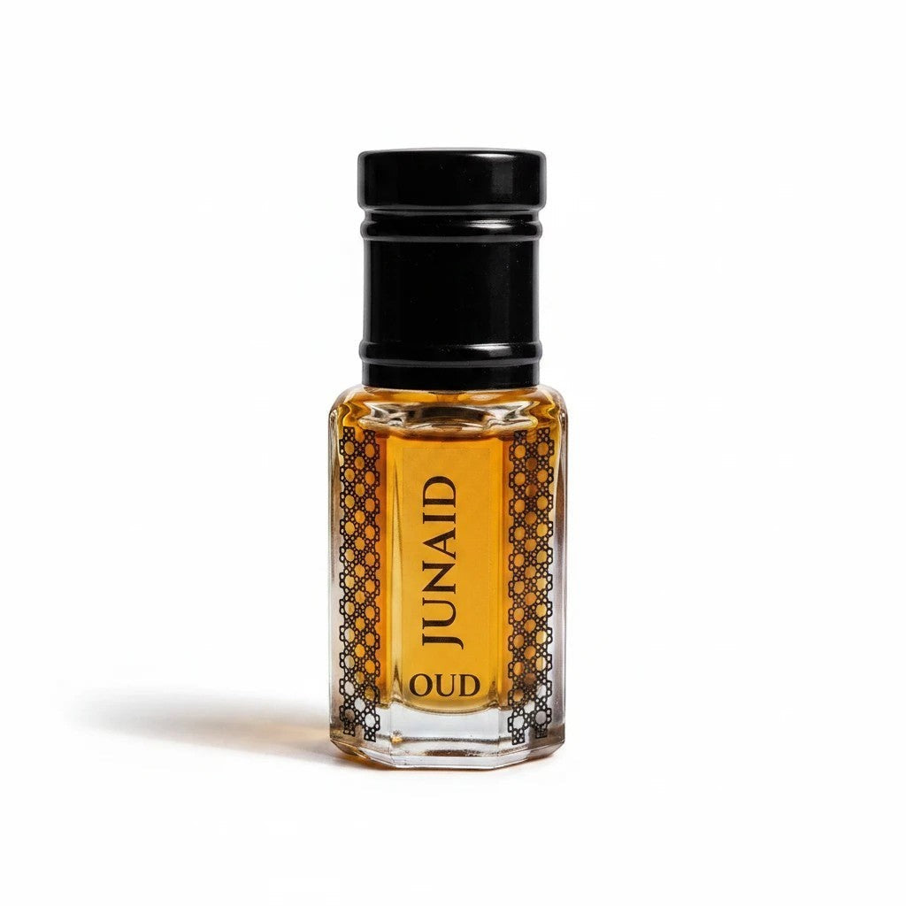 fragume JUNAID Oud concentrated perfume oil in a decorative glass bottle with a black cap and golden amber liquid.