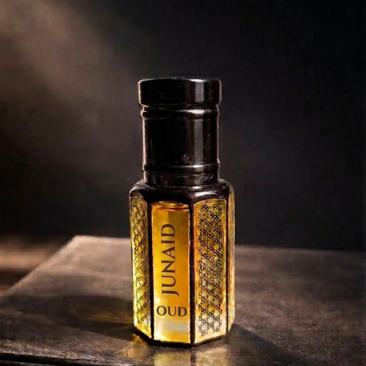 fragume JUNAID Oud concentrated perfume oil in an elegant glass bottle with gold liquid and black cap