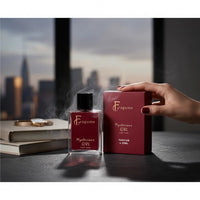 fragume Mysterious Girl Parfum 50ml glass bottle and burgundy box on a desk with a woman's hand and city skyline view