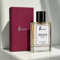 fragume Pious Eau De Parfum for her in a 50ml glass bottle next to a textured magenta gift box on a white surface