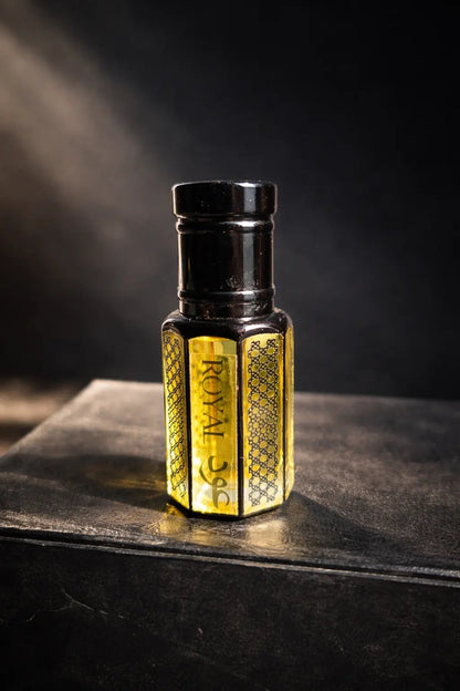 fragume Royal Oud Attar concentrated perfume oil in an elegant hexagonal glass bottle with intricate gold detailing.