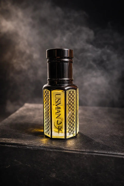fragume USMAN Oud Attar in a hexagonal glass bottle with geometric patterns, set against a dark, smoky background.